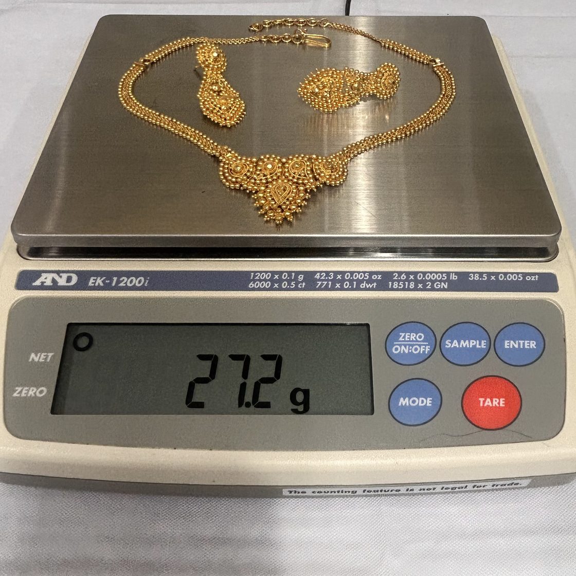 Ornate necklace & earring set on the GoldVara scale